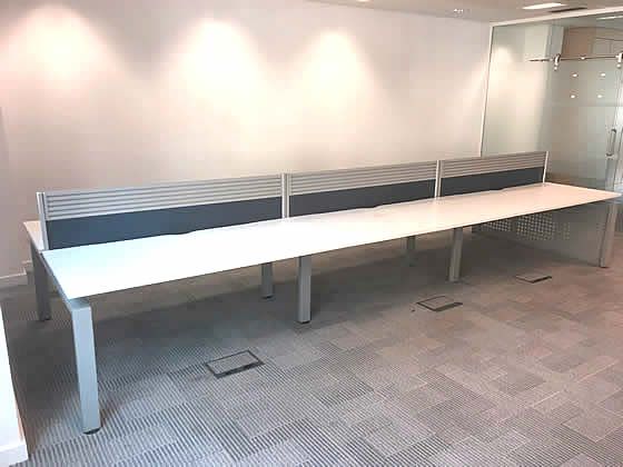 1600mm Senator Freeway Bench Desking with white tops, silver goalpost legs and desk dividing screens included. 