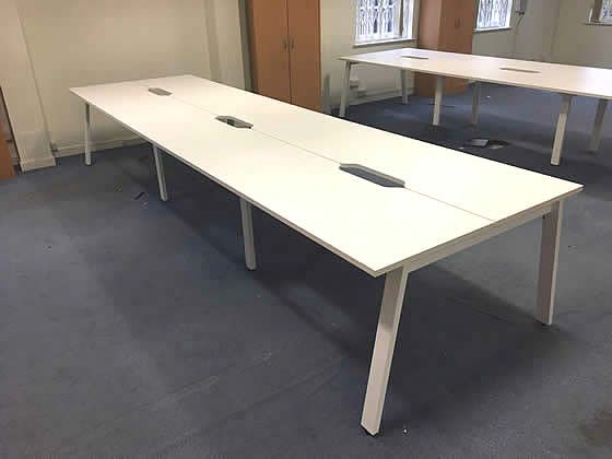 1400mm White bench desks with white 'A frame' legs, scoop tops and cable trays included.