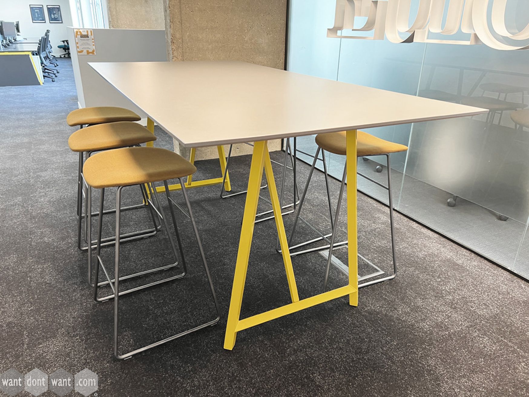 Used high meeting table with light grey top and yellow metal legs.