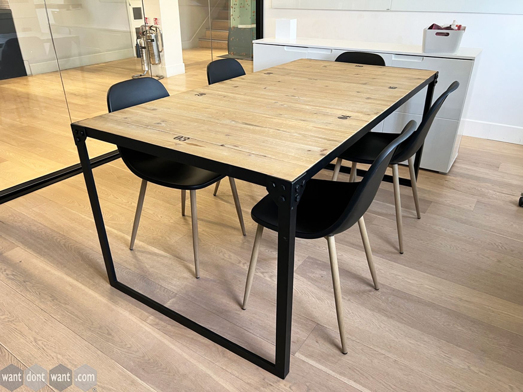 Used meeting table with steel black frame and wood panelled top.