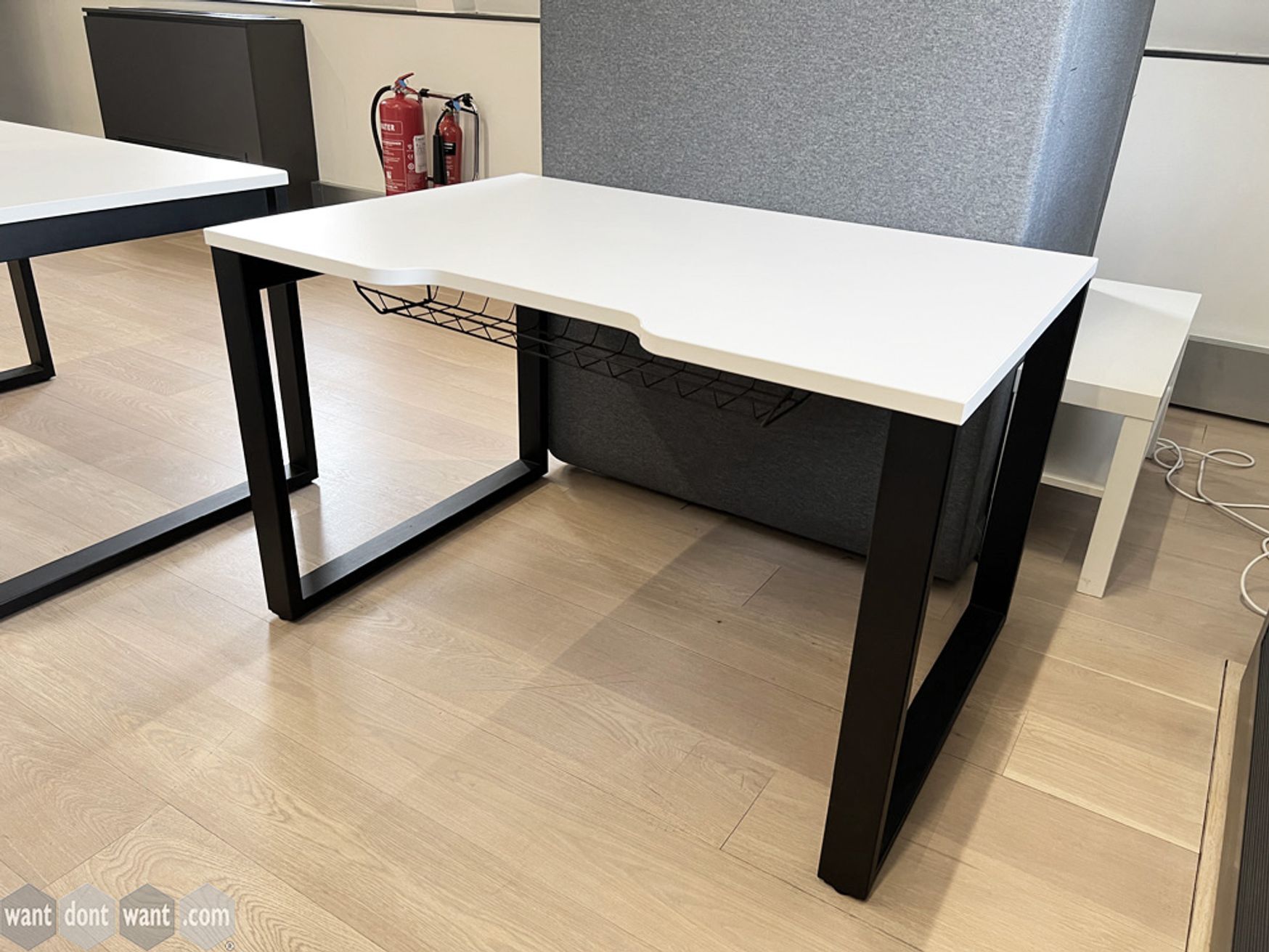 Used white 1200mm wide free-standing white desks with black steel legs.