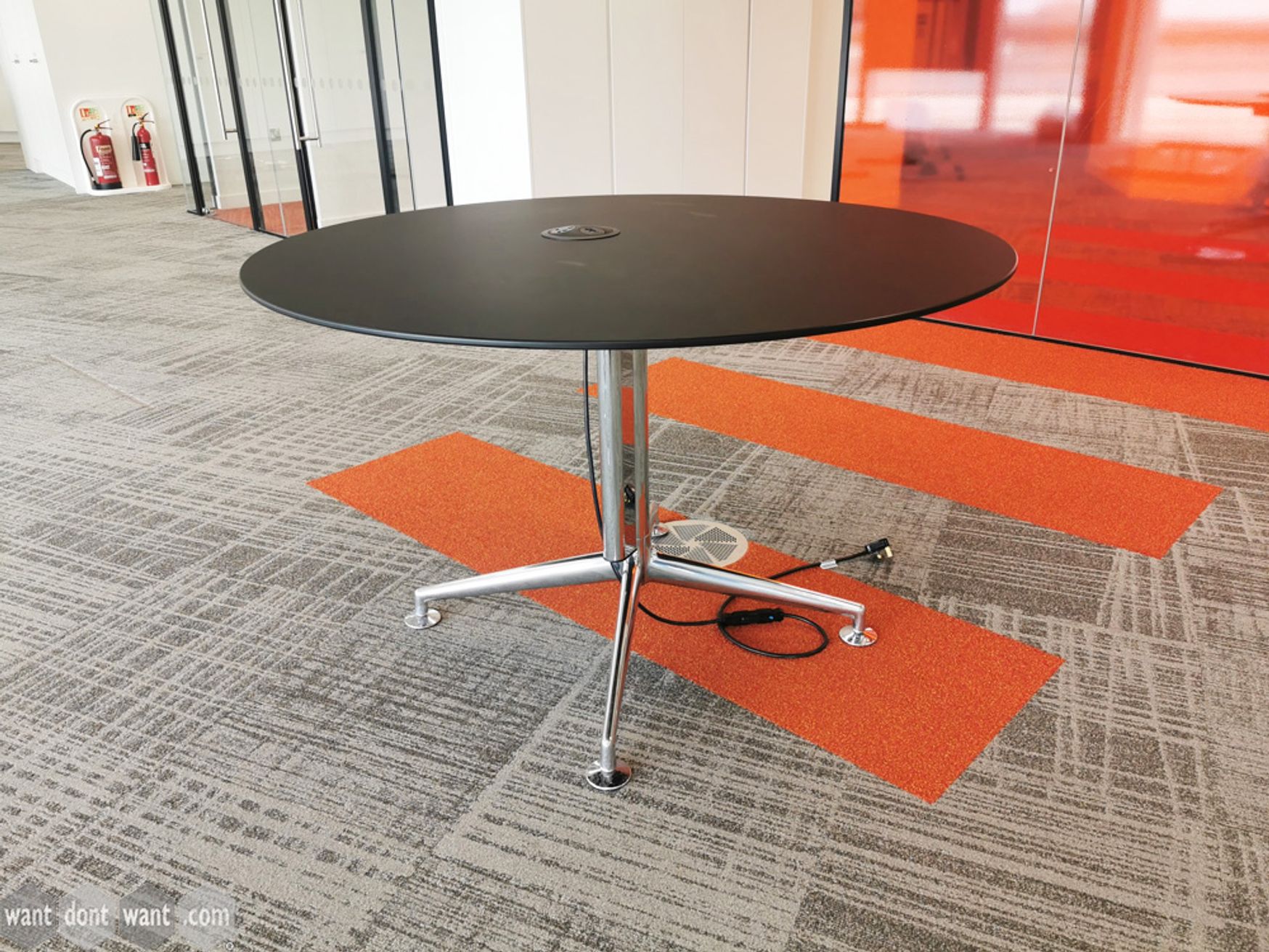 Used black circular meeting table with polished aluminium base