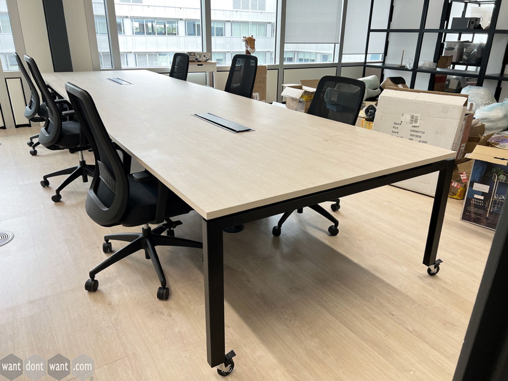 Used 4800mm 8-person bench desks with white oak top and black legs on castors
