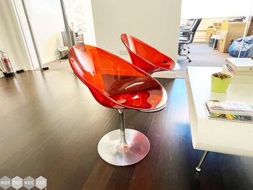 Used red plastic transparent swivel chairs on silver base
