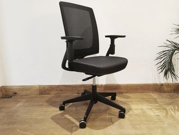 Large quantity of used mesh-back 'Hon' task chairs with black upholstered seat and adjustable arms.