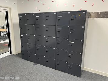 Used 10-compartment locker modules with combination locks in graphite grey metal.