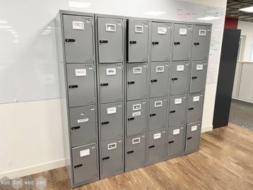 Used 4-compartment locker units in grey metal finish.