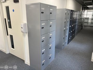 Used 10-compartment locker modules with combination locks in light grey metal.
