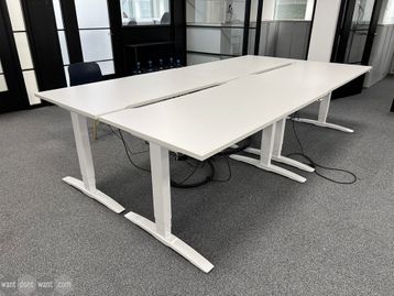 Used OMT electric height-adjustable desks with white tops and legs.