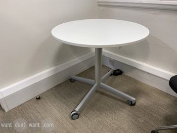 Used Bene height-adjustable table with white top and silver column base.