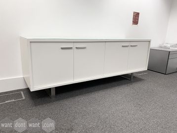 Used white 4-door credenza with glass top.