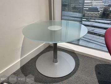 Used circular glass coffee table with silver column base