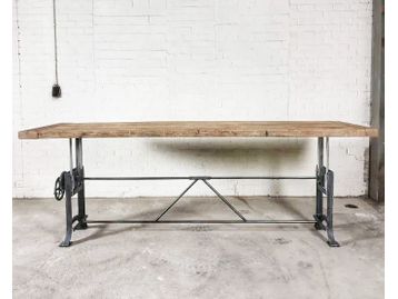 Used industrial reclaimed oak meeting table with height-adjustable base.