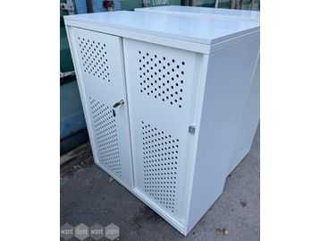 Used white storage cupboards with white perforated sliding doors.