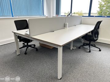 A used 4-person white bench desk with each desk position measuring 1400mm wide. 