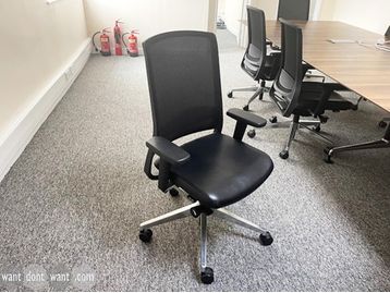 Used Gispen task chairs with black leather seats and mesh backs.